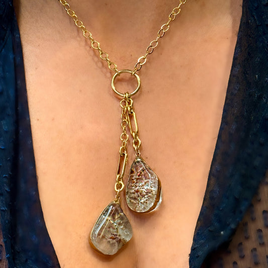 model chest wearing a two stone blue beryl lariat gold necklace