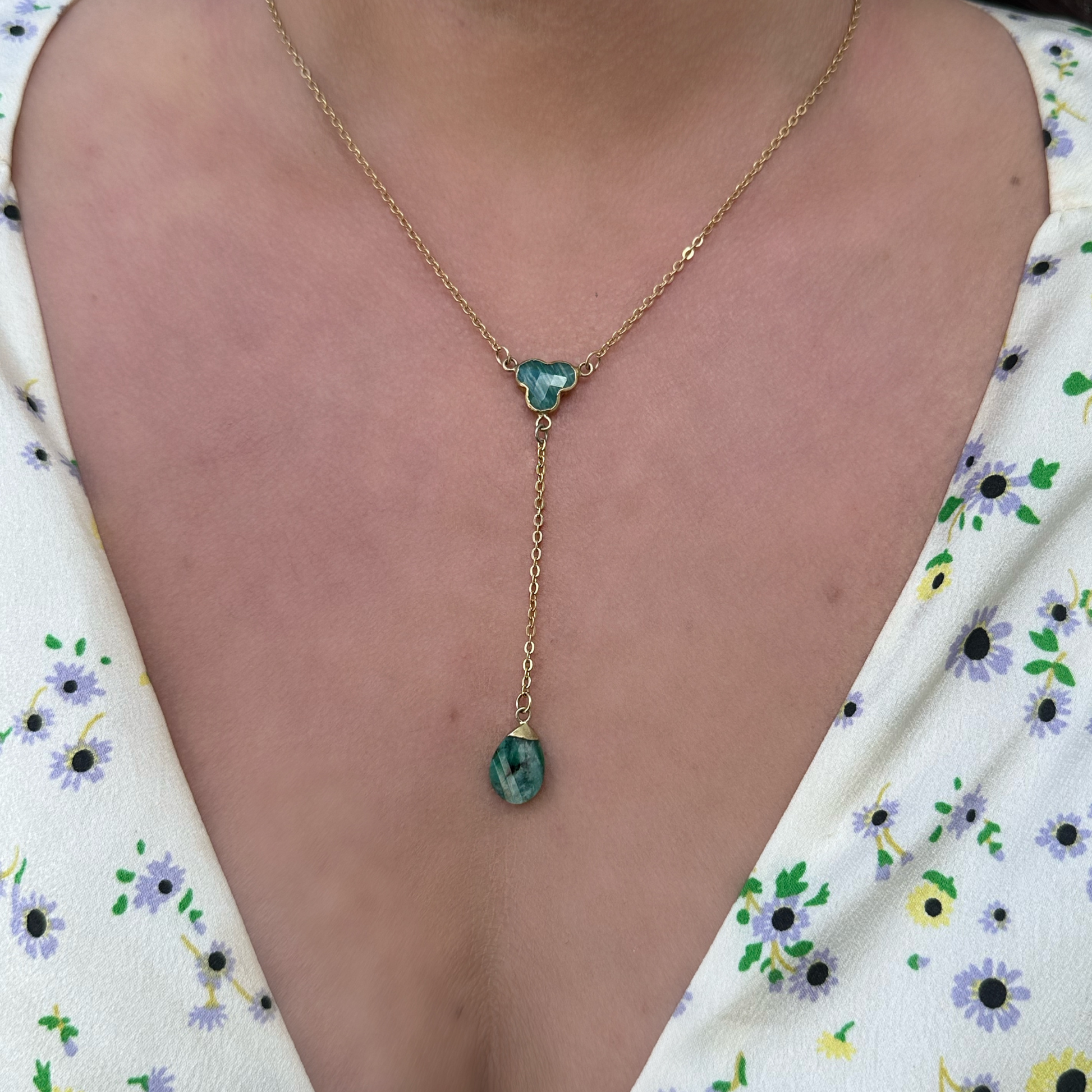 Gold-malachite-lariat-necklace-on-model-with flower-top
