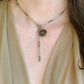 model-wearing-a-paper-clip-necklace-two-tone-silver-and-gun-metal-hammered-with-a-coing-pendant-small-in-silver-belaroca-ejewelry
