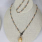 display-of-a-paper-clip-multi-tone-necklace-and bracelet-with -a-pearl-pendant-hanging-from-necklace-belaroca-jewelry